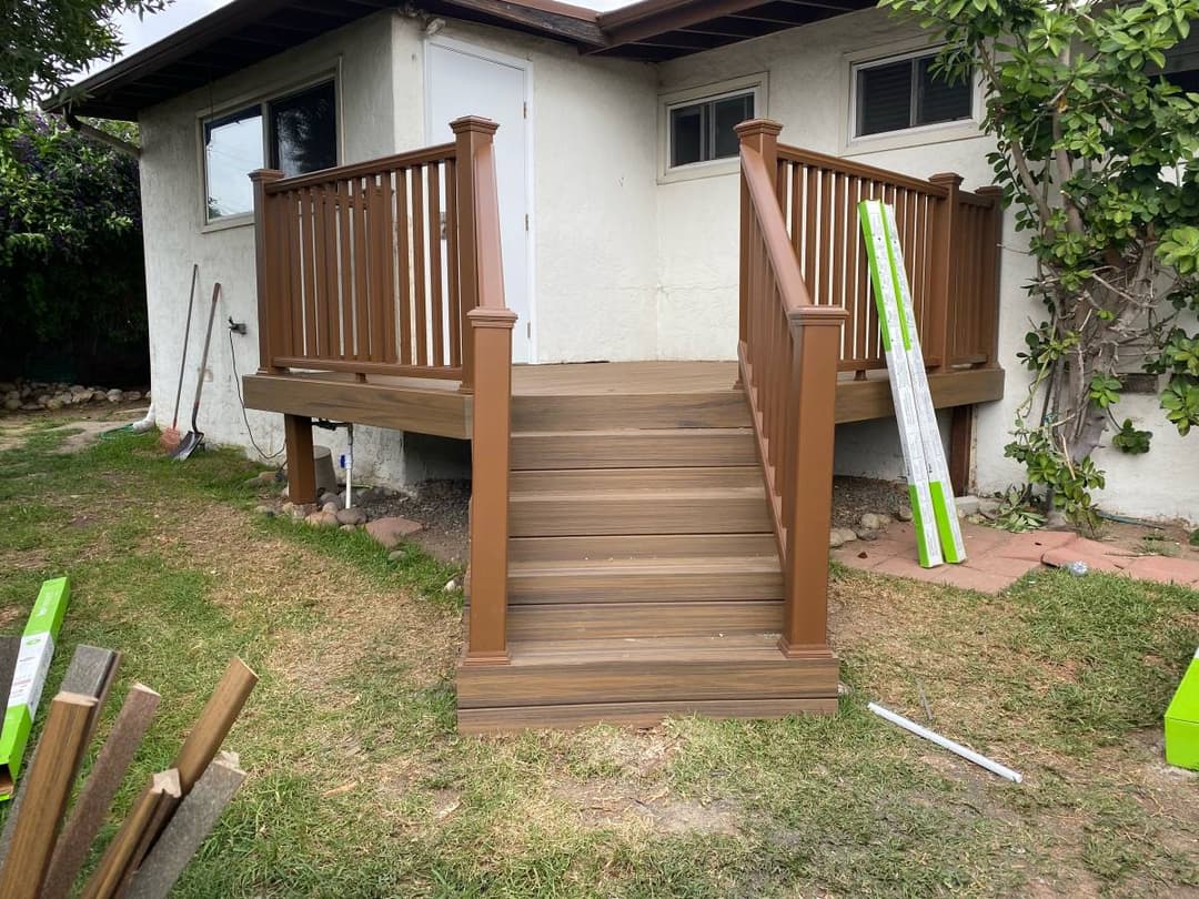 picture of a new wooden deck and staircase in a backyard